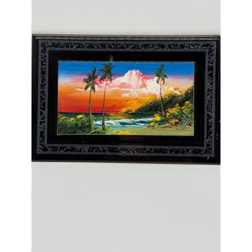 Hand-painted tile featuring a beach scene with palm trees at sunset.